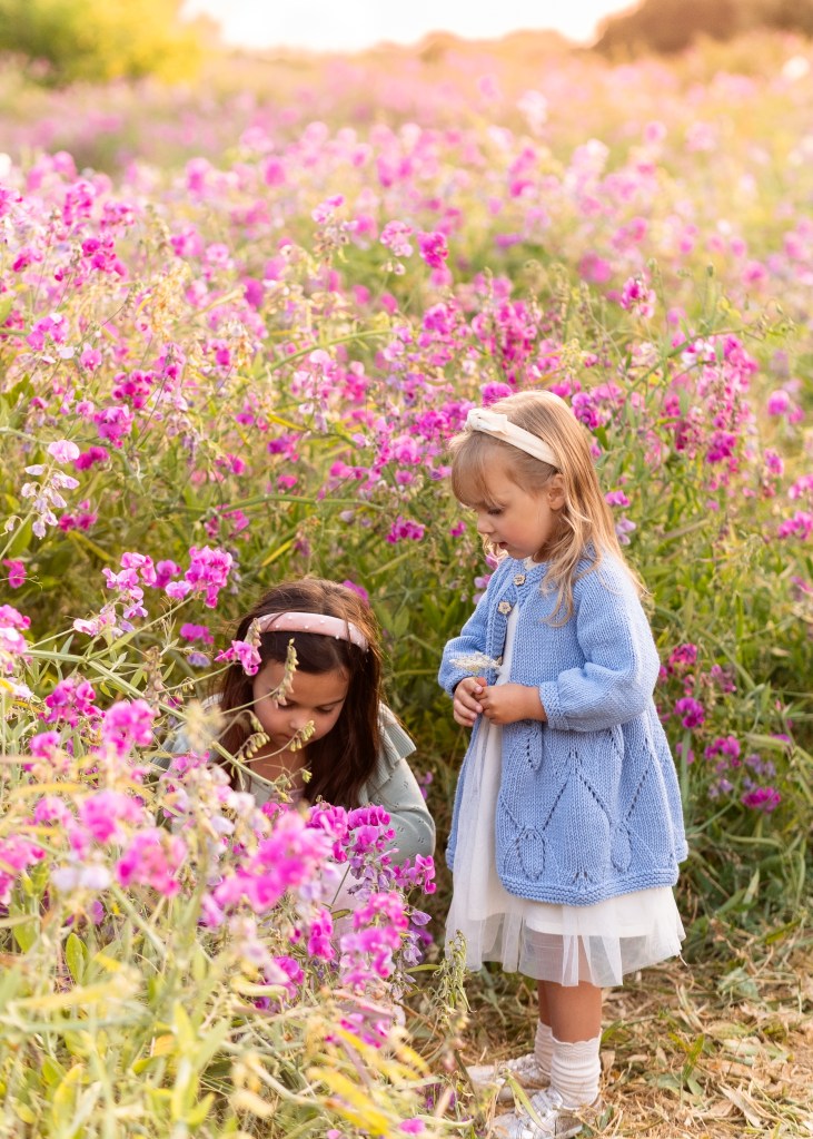 Two little girls in field of wildflowers in Seattle WA during Golden Hour